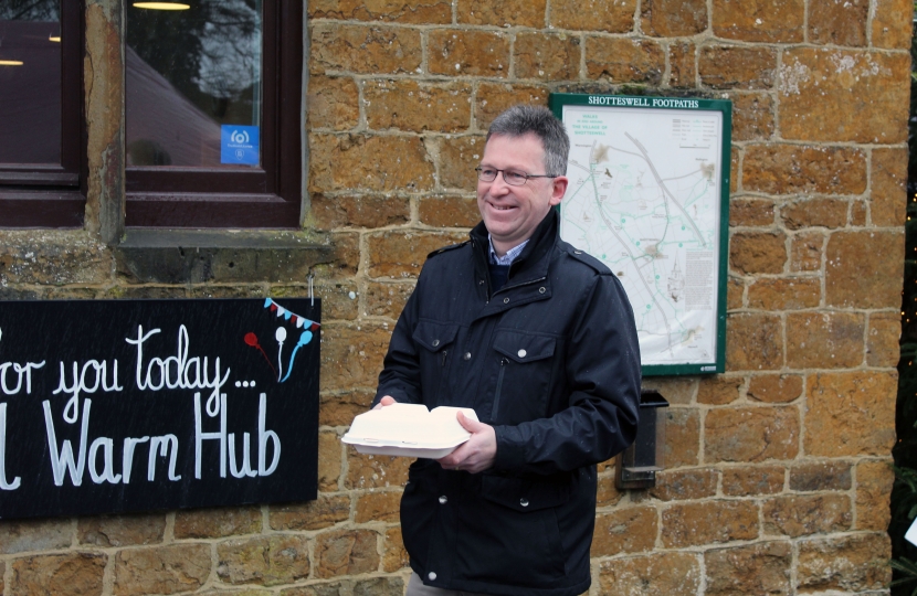 Jeremy standing for a press photograph outside the village hall